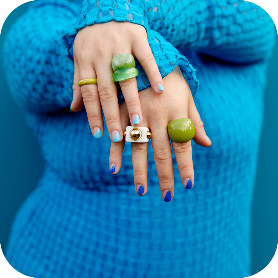 Woman dressed in blue showing her rings