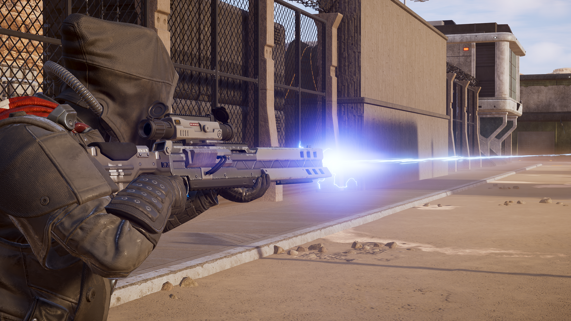 A Helldiver fires an energy weapon across a concrete compound in an official Helldivers 2 screenshot.