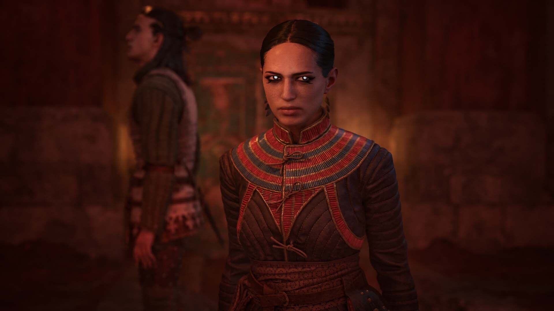 A glowing-eyed vampire stands in front of Coen in a dim chamber