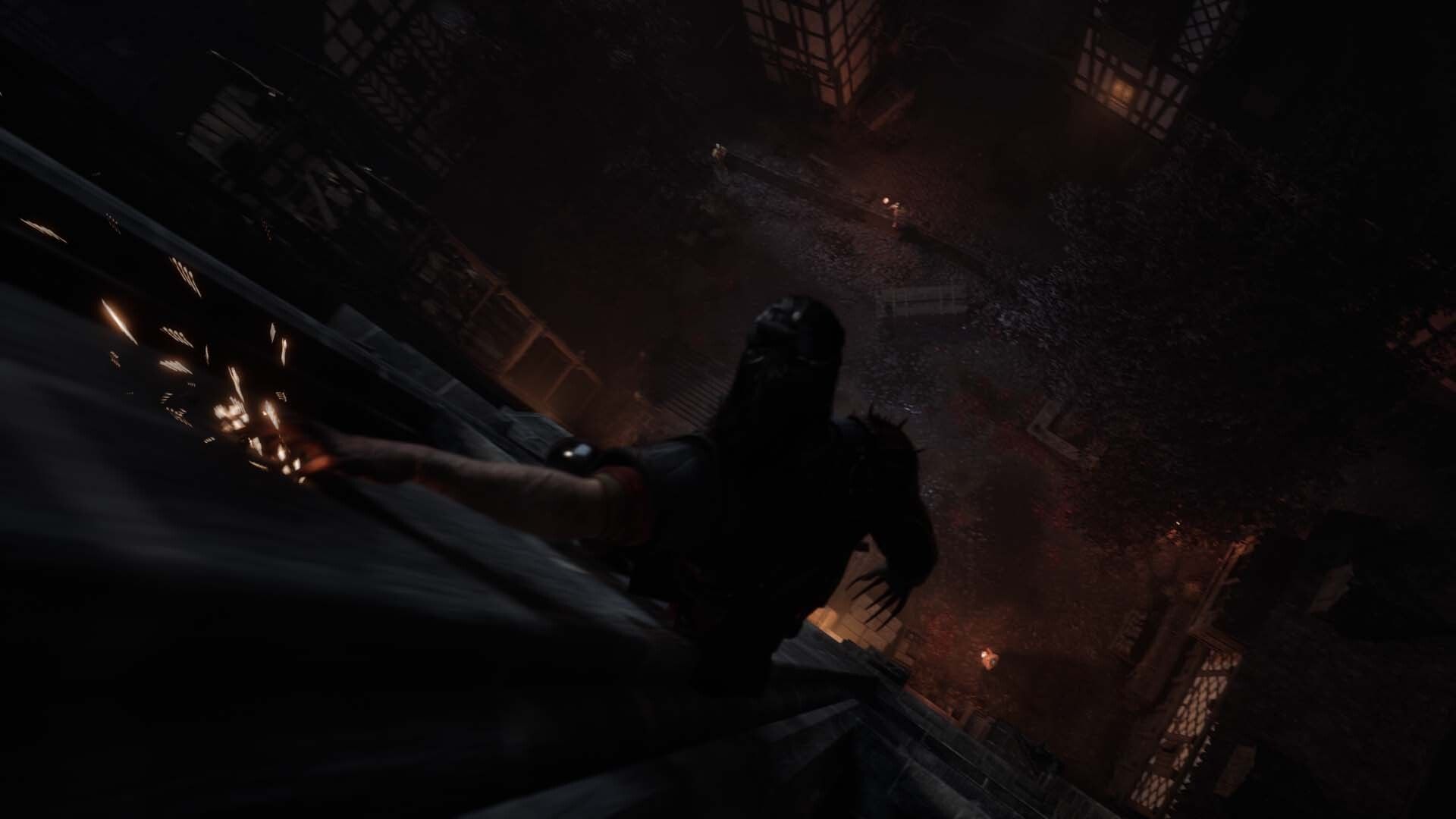 Coen moves down a steep rooftop above a city street at night