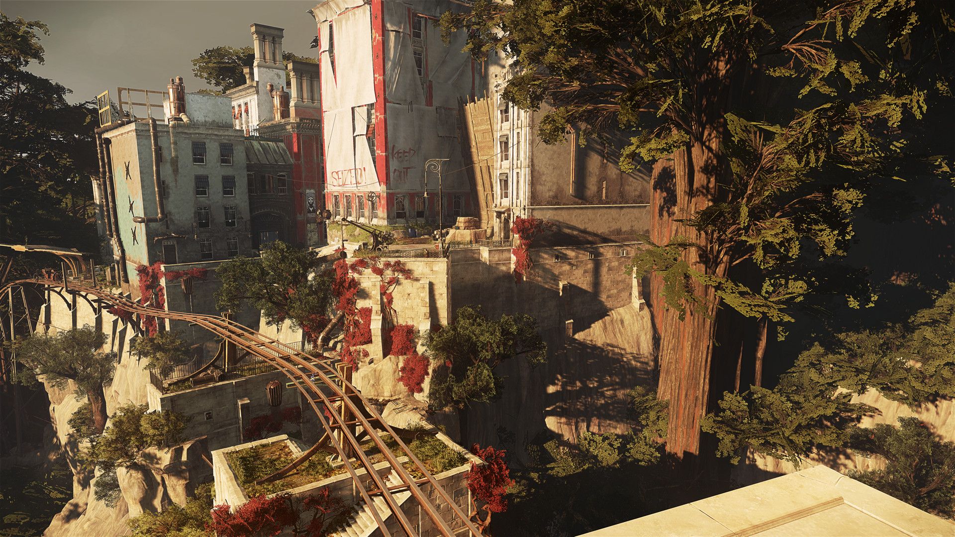 Karnaca buildings and elevated tracks arranged across a sunlit hillside