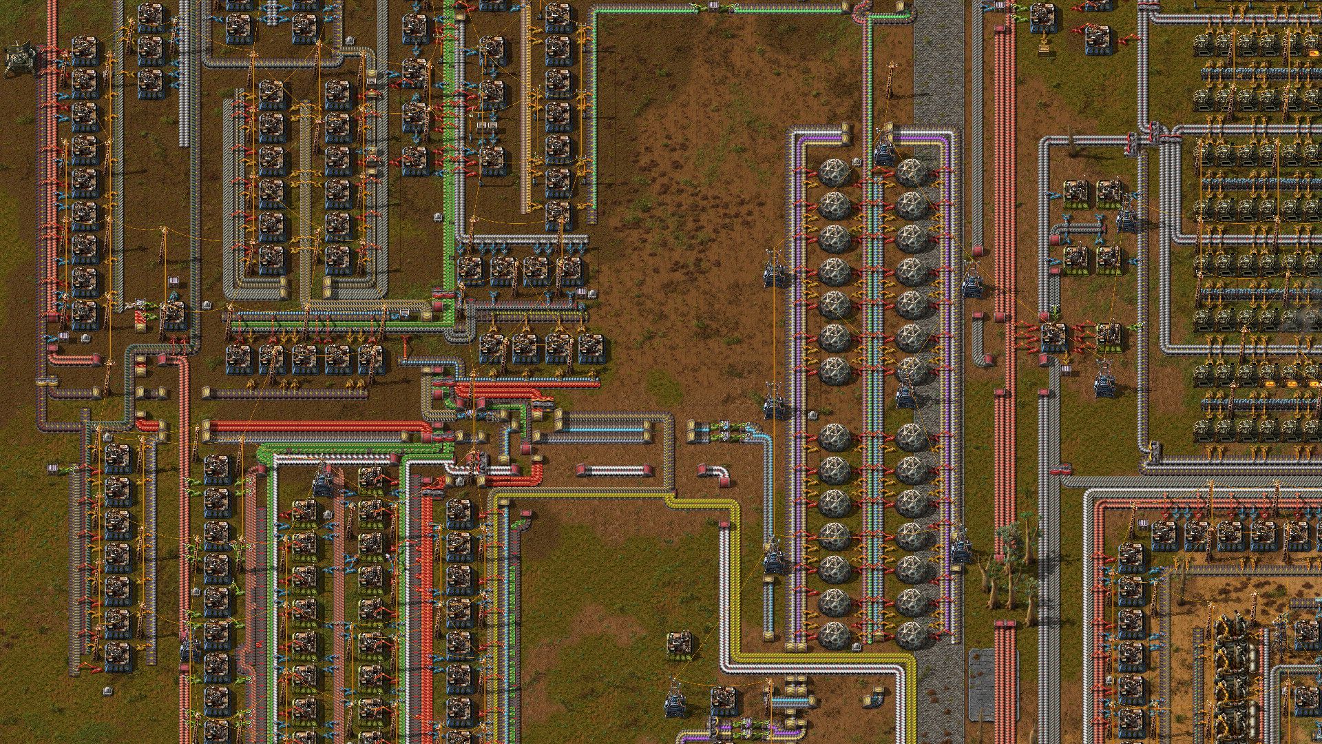 Factorio belts carrying materials through a factory