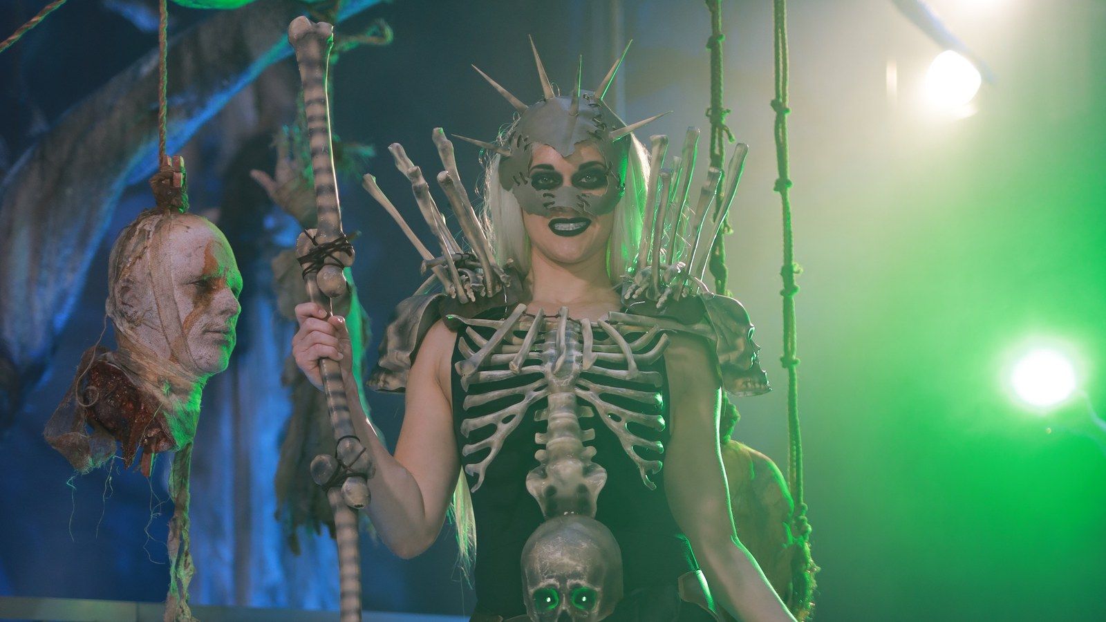 An attendee wearing a bone-themed costume and carrying a staff at an earlier ExileCon.