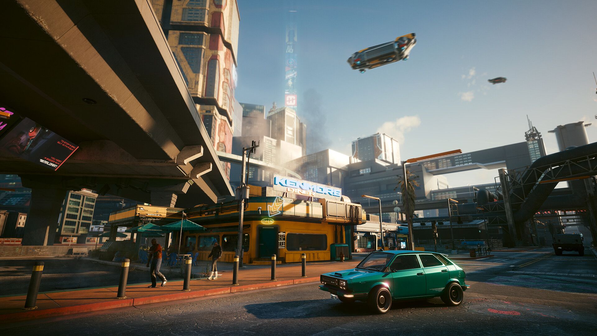 A diner and passing cars beneath elevated roads in an official Cyberpunk 2077 screenshot.
