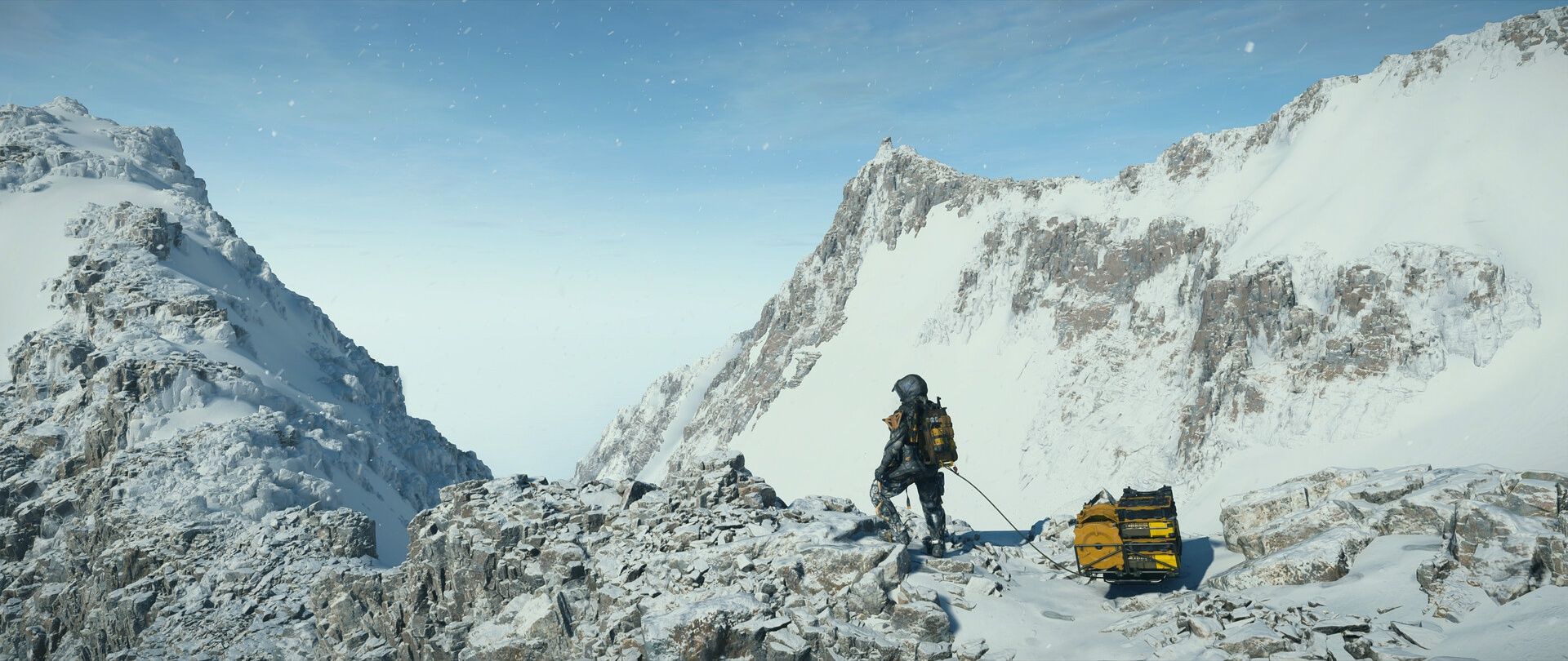 Sam crosses a snowy route in Death Stranding 2 with cargo nearby.