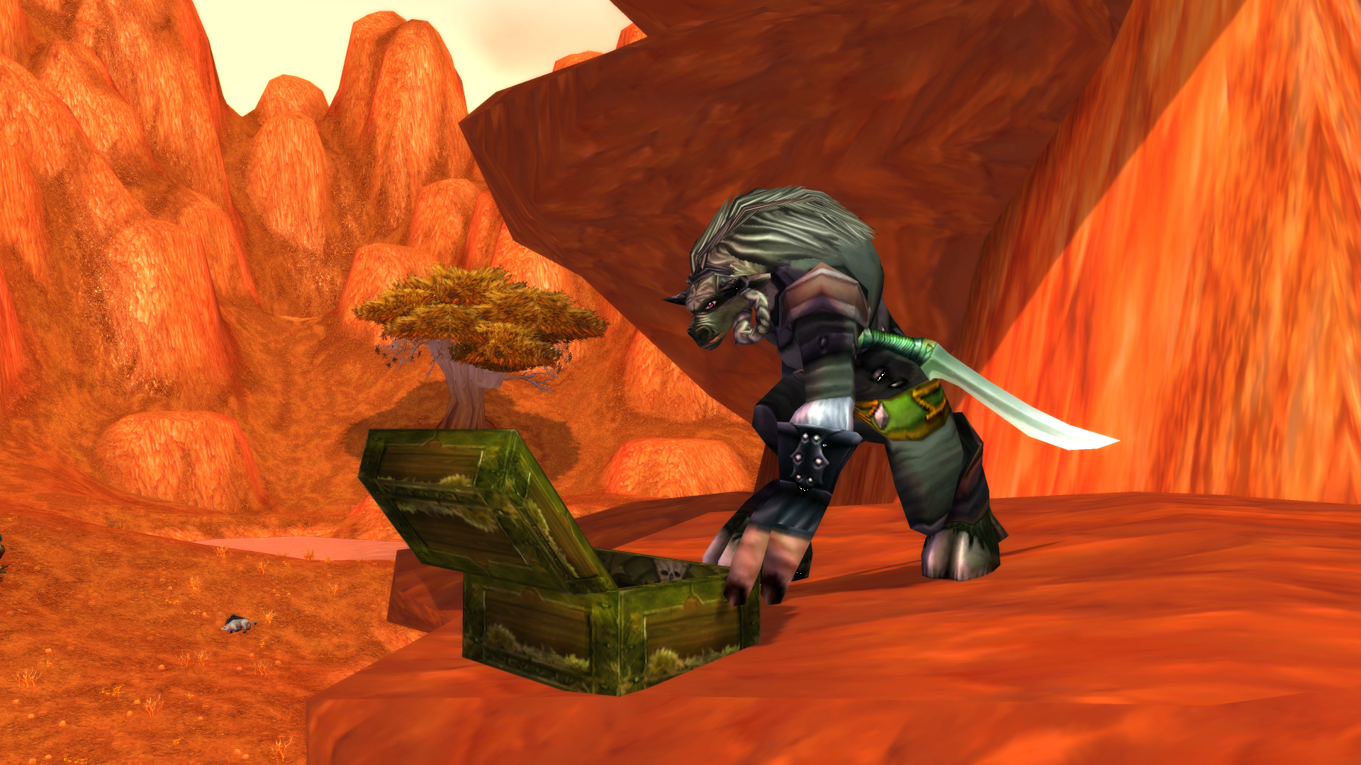A wolf-like enemy beside an open chest in an orange-rock canyon in official World of Warcraft Classic imagery