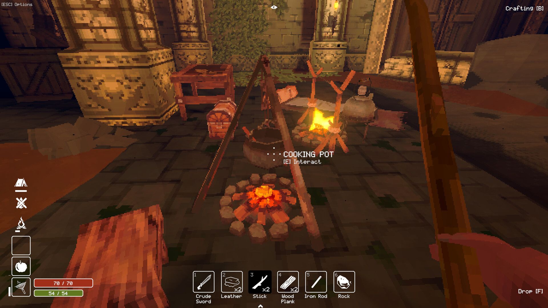 A cooking pot and campfire inside the Deep Dish Dungeon camp