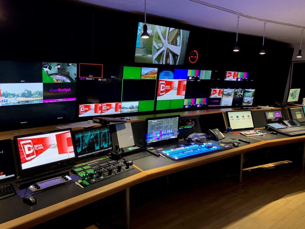 Telebasel broadcast control room with a wall of monitors, vision mixer and production desks
