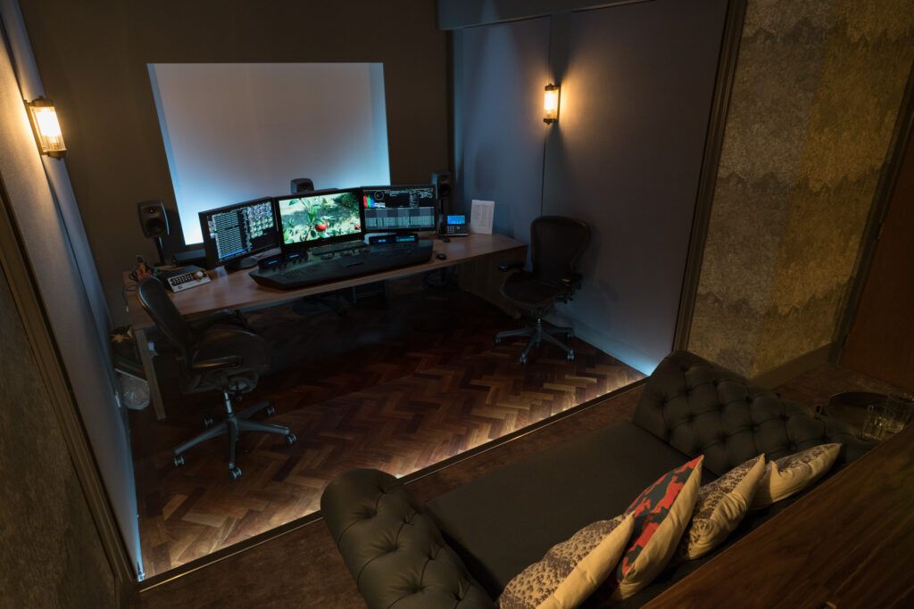 Directors Cut Films grading suite with monitors, control desk and client sofa
