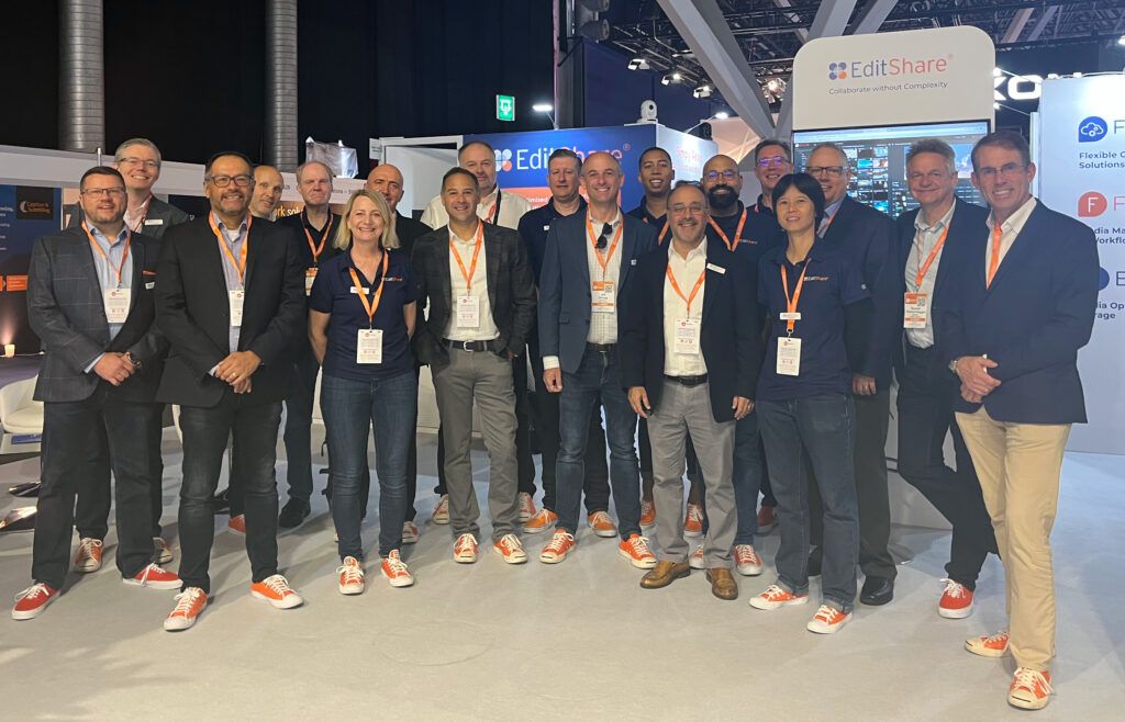 EditShare team in matching orange sneakers posing at the EditShare stand at IBC 2022