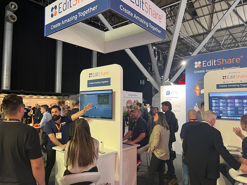 Visitors watching product demos at the EditShare stand at IBC 2023