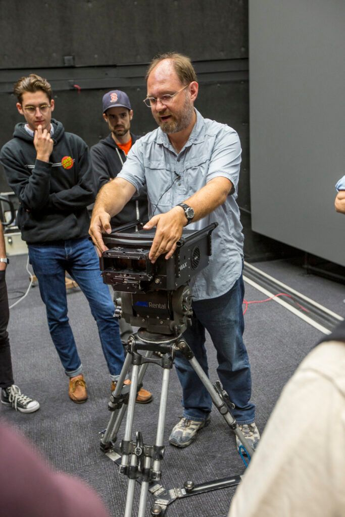 Matt Scott demonstrating an IMAX camera to students at USC School of Cinematic Arts