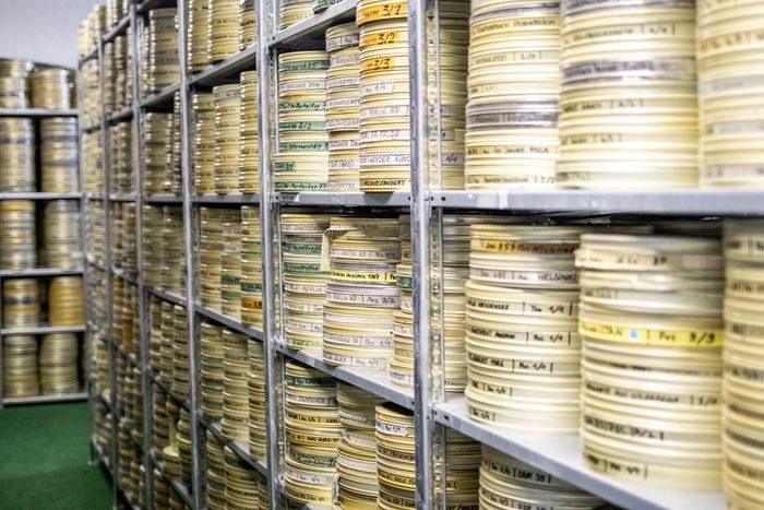 Shelves of labelled film canisters in the PROGRESS film archive