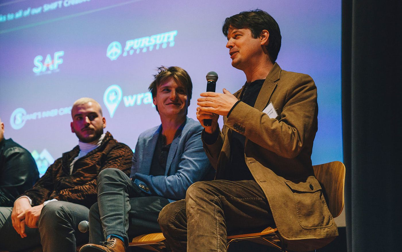 Filmmakers on stage with a microphone during the Shift Creative Fund Showcase panel
