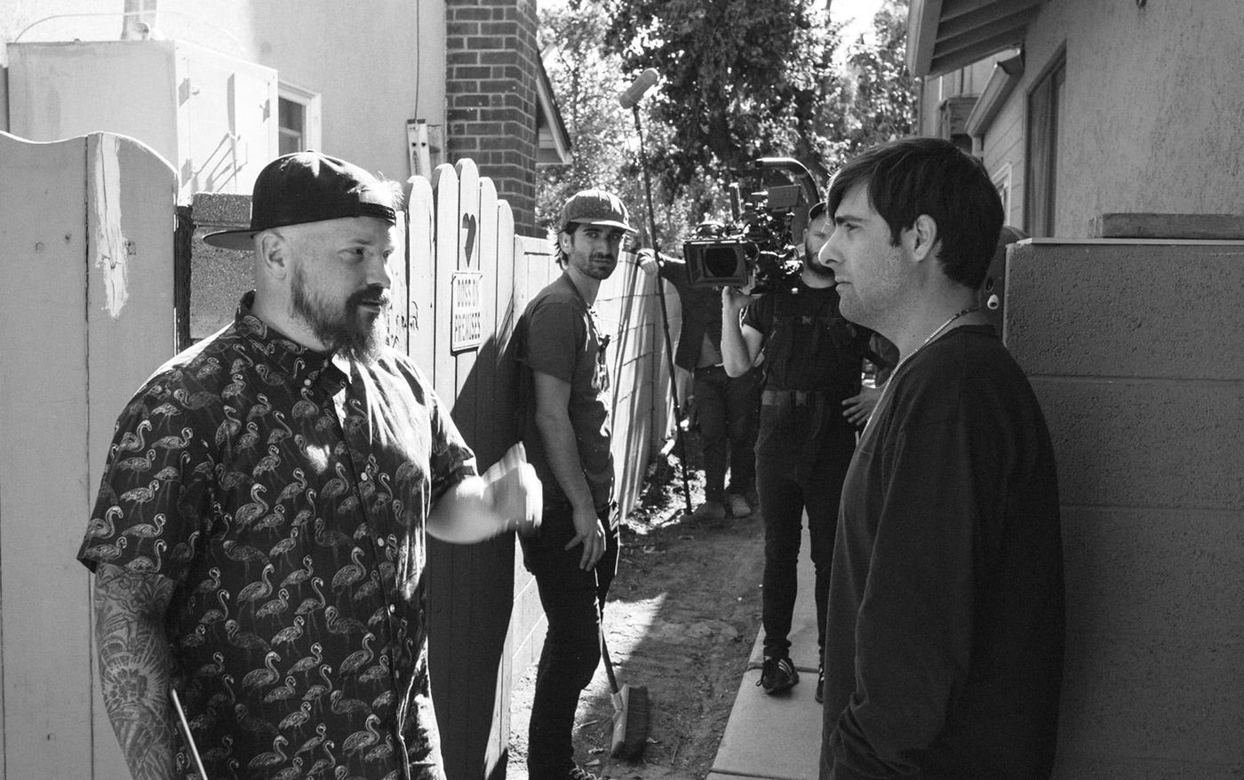 Director Kyle Cogan talks with actor Jason Schwartzman on the set of Bad Assistant
