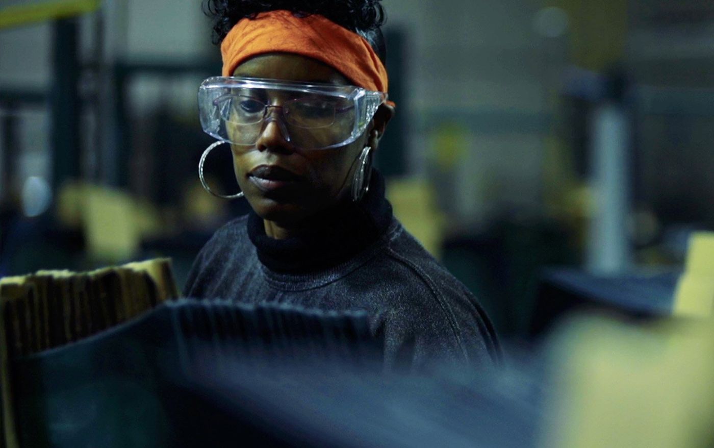 Still of Shawnea Rosser in safety goggles at the factory in American Factory