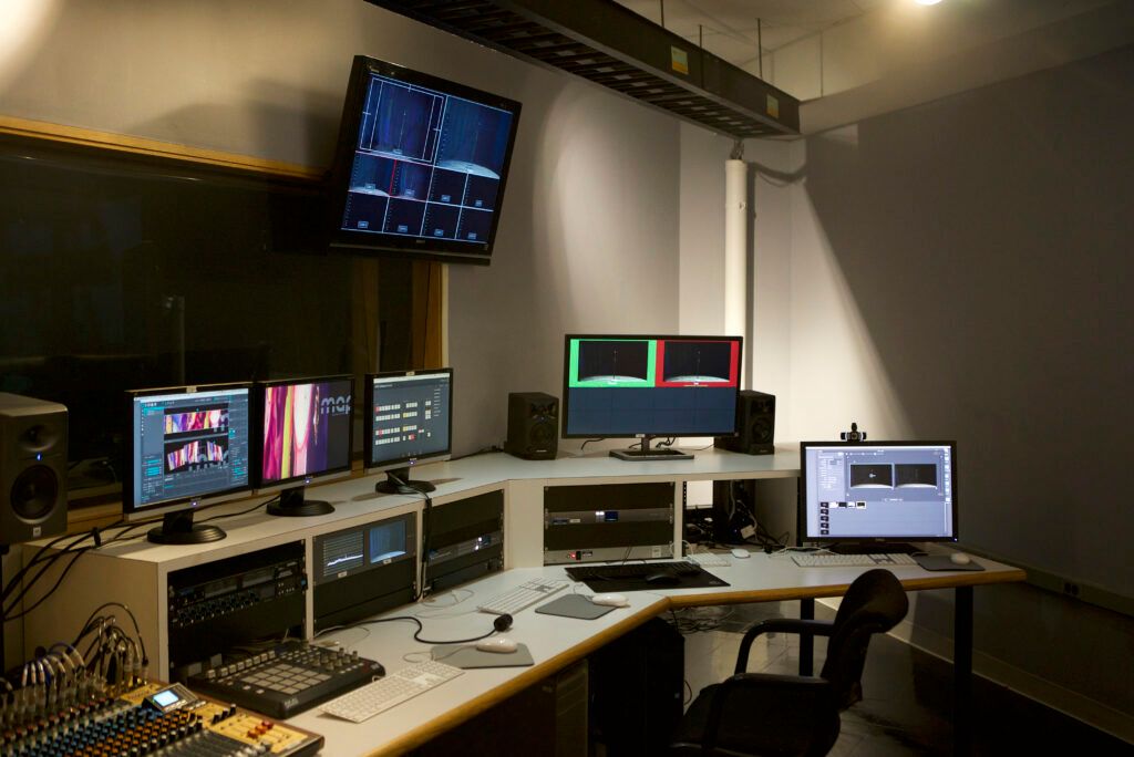 Media production control room at Massachusetts College of Art and Design with multiple monitors, mixing desk and rack gear