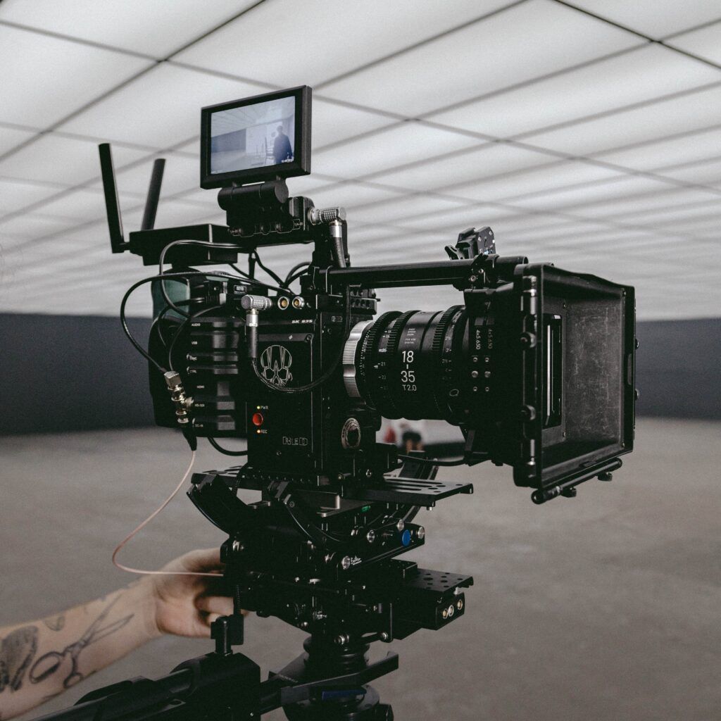 RED cinema camera rig with monitor and matte box on a tripod
