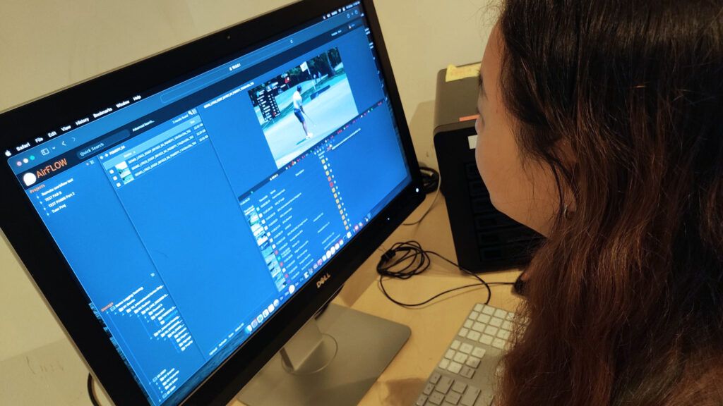Editor reviewing golf footage in EditShare AirFLOW on a desktop monitor
