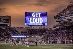 Kansas State football stadium at dusk with GET LOUD on the video board