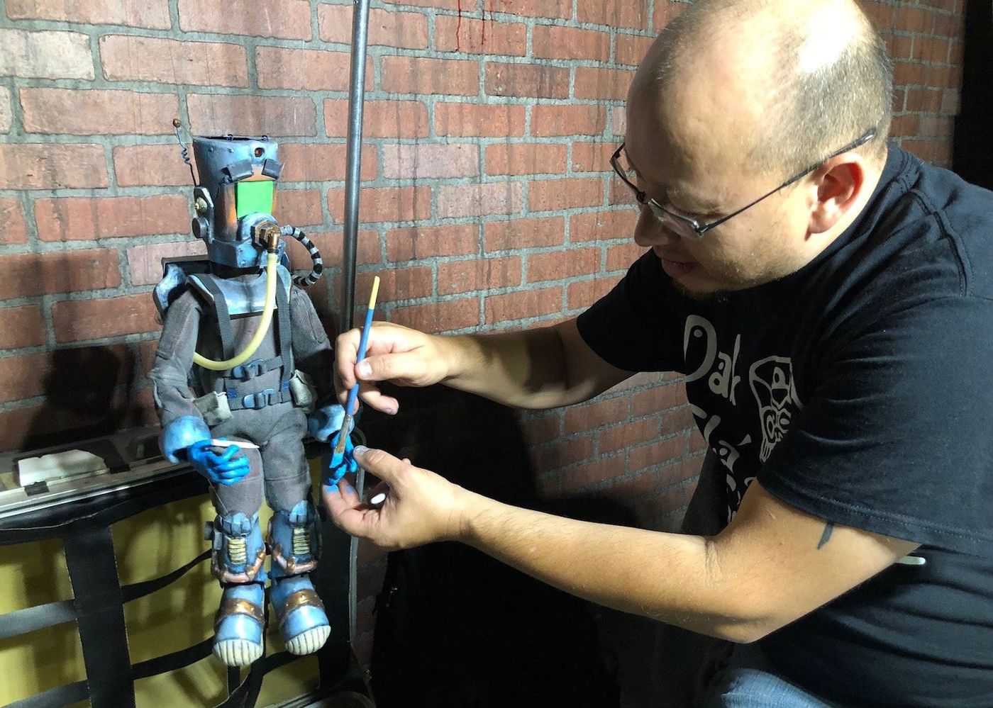 Producer and director Sam Koji Hale adding finishing touches to the robot diver marionette Stan
