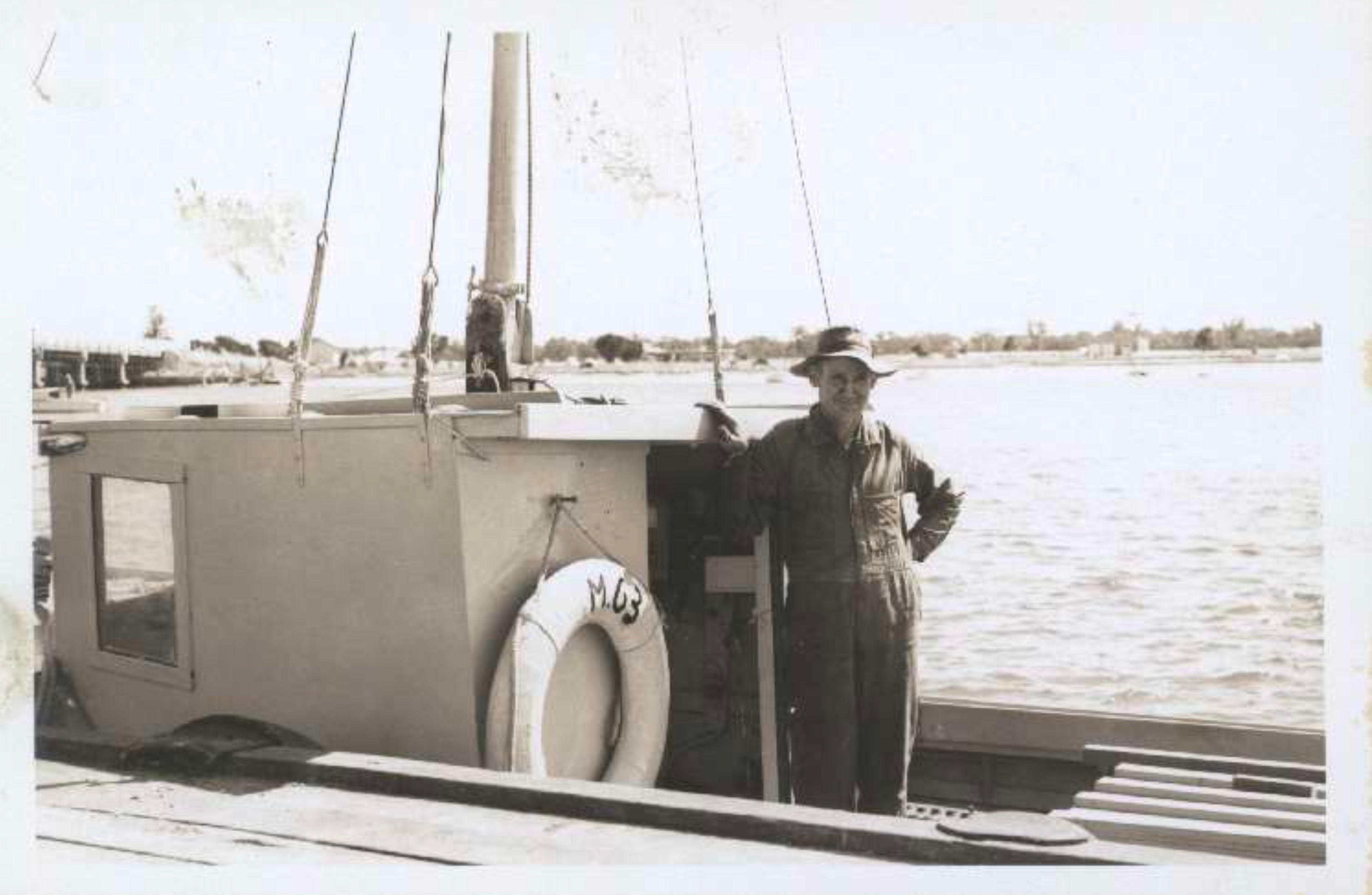 Old black and white photo of Hugh Gill standing onboard Avaneta