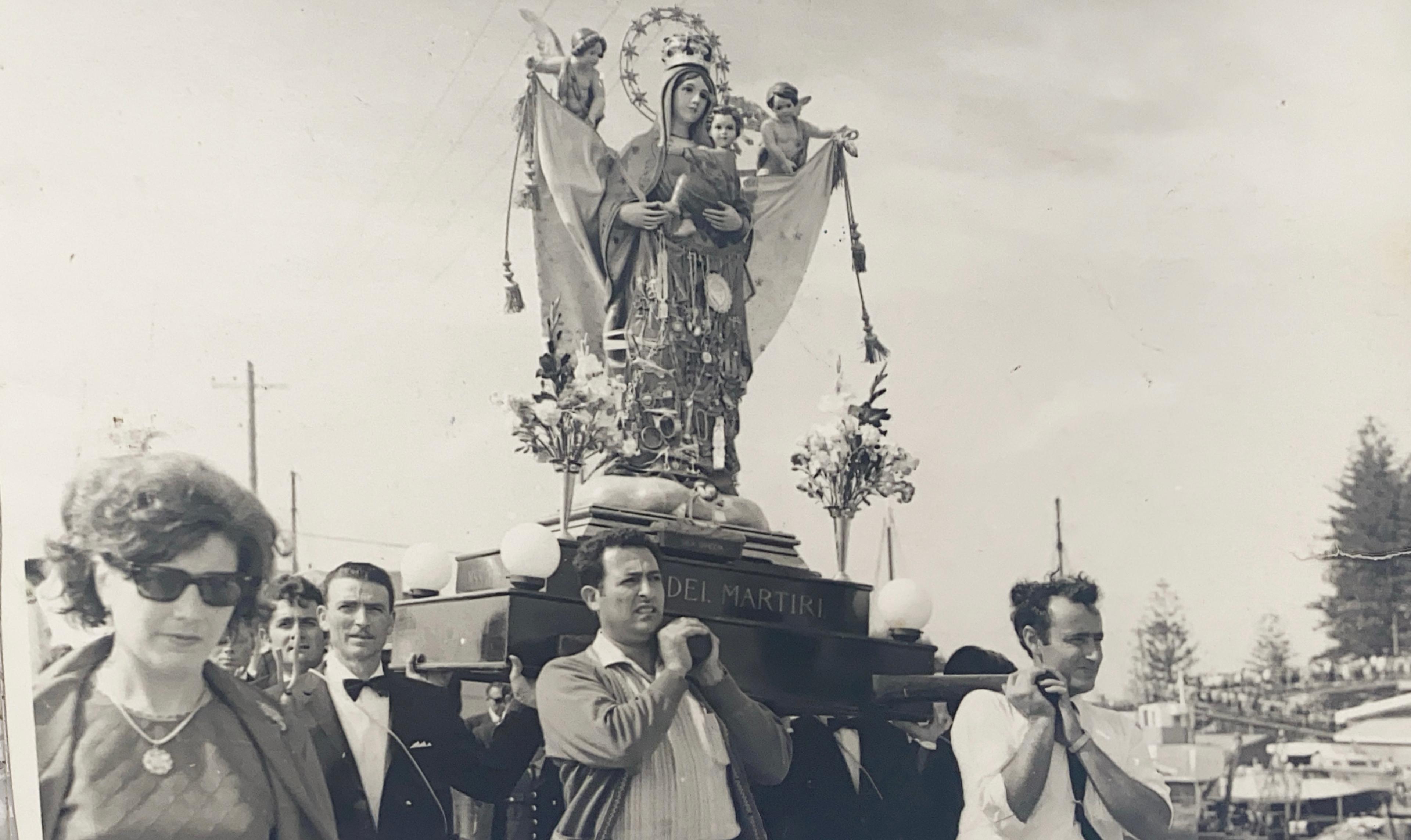 Guiseppe Pittorino assists carrying the Madonna