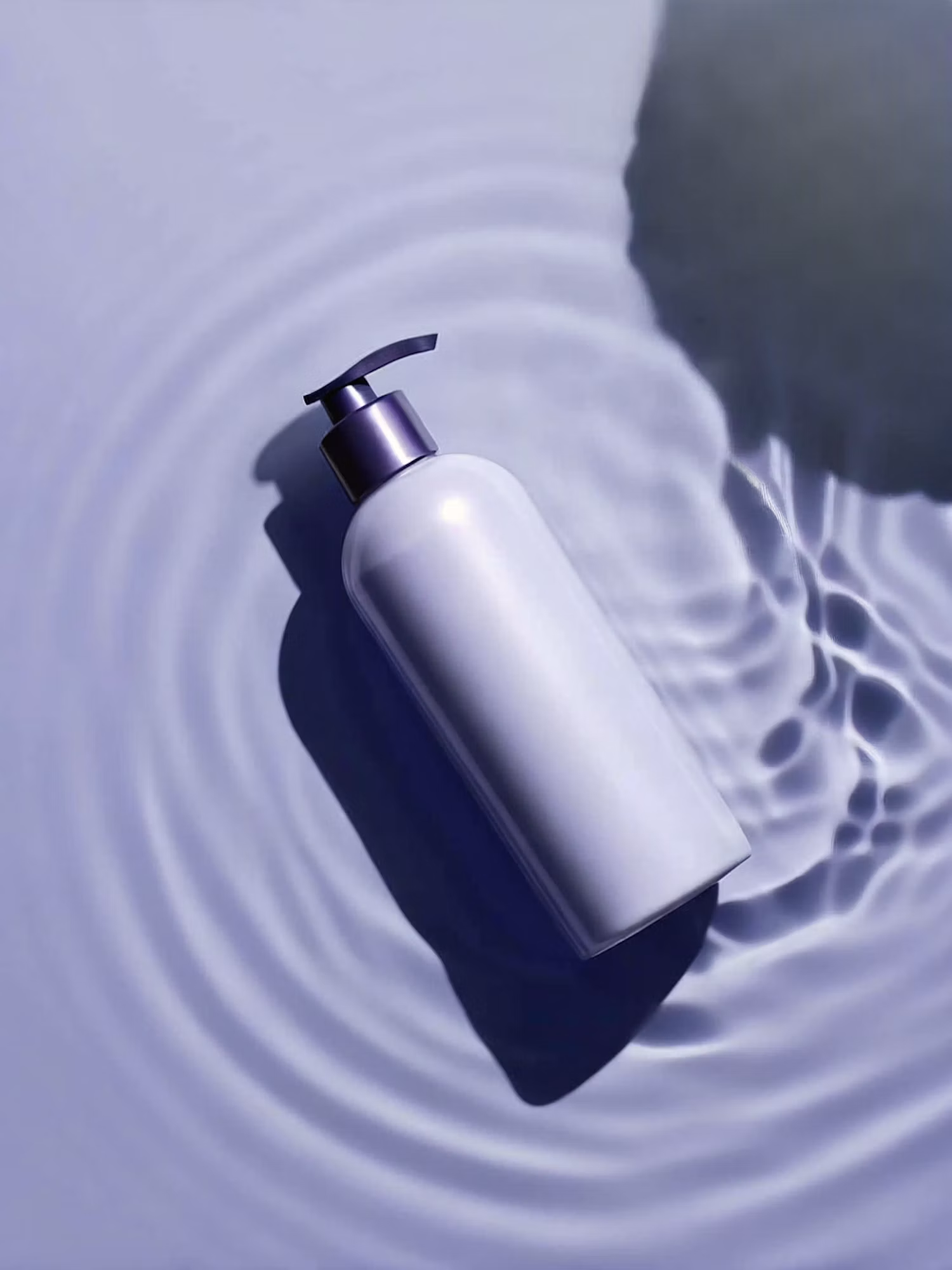 Lilac bottle resting on rippling water