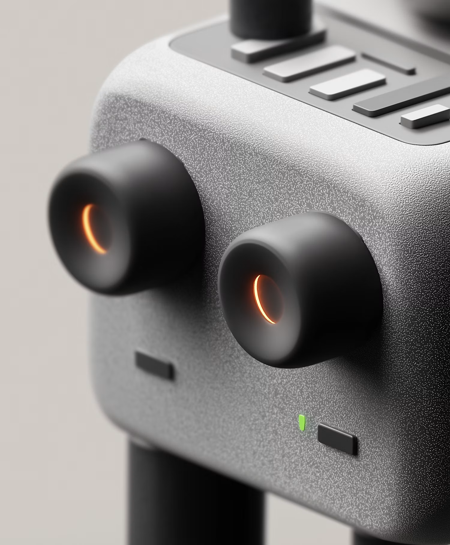 Black earbuds with orange glow on a grey speaker