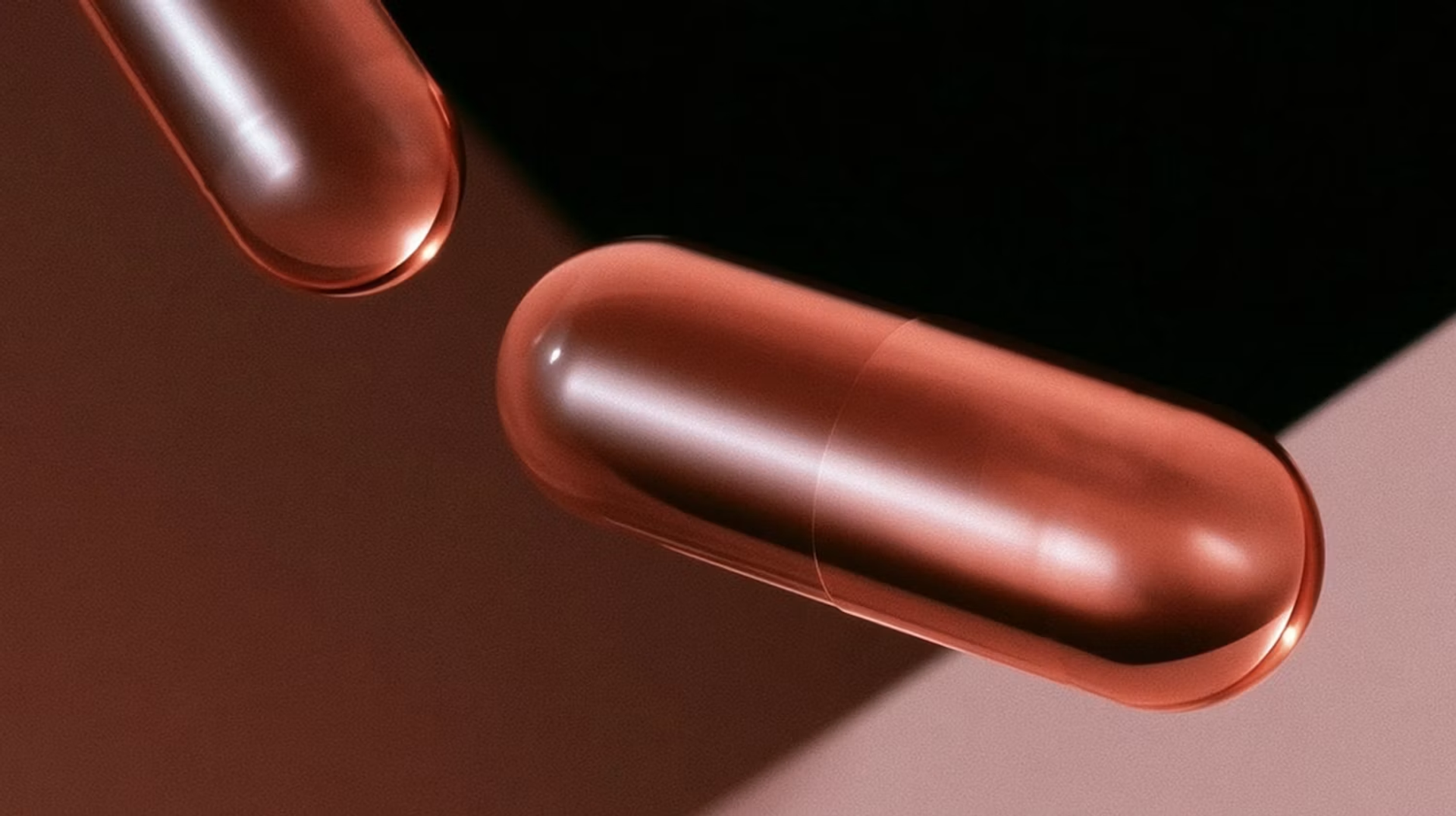 Glossy red capsules on a dark background