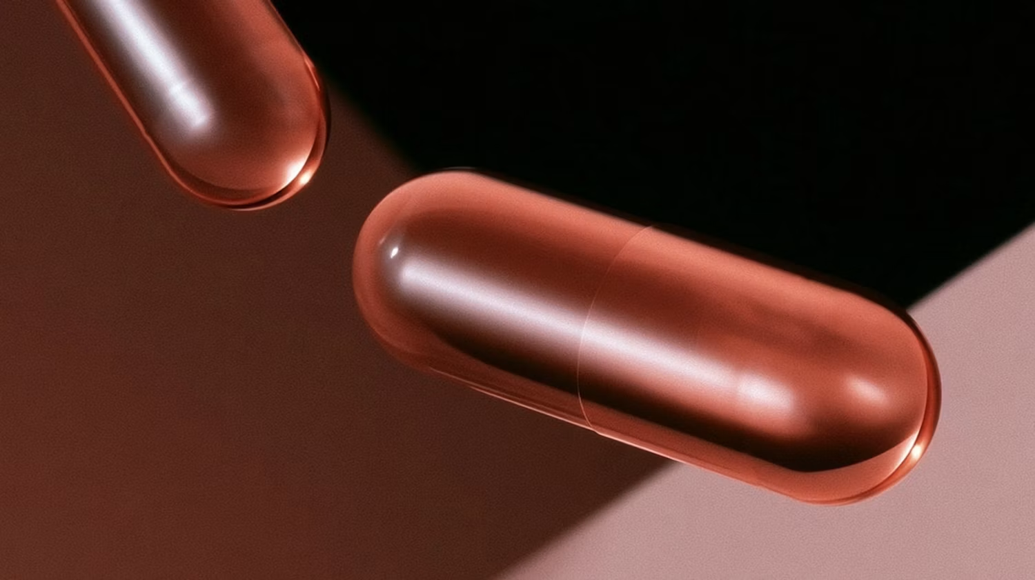 Glossy red capsules on a dark background