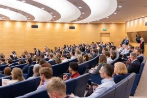 a large group of people are sitting in an auditorium .