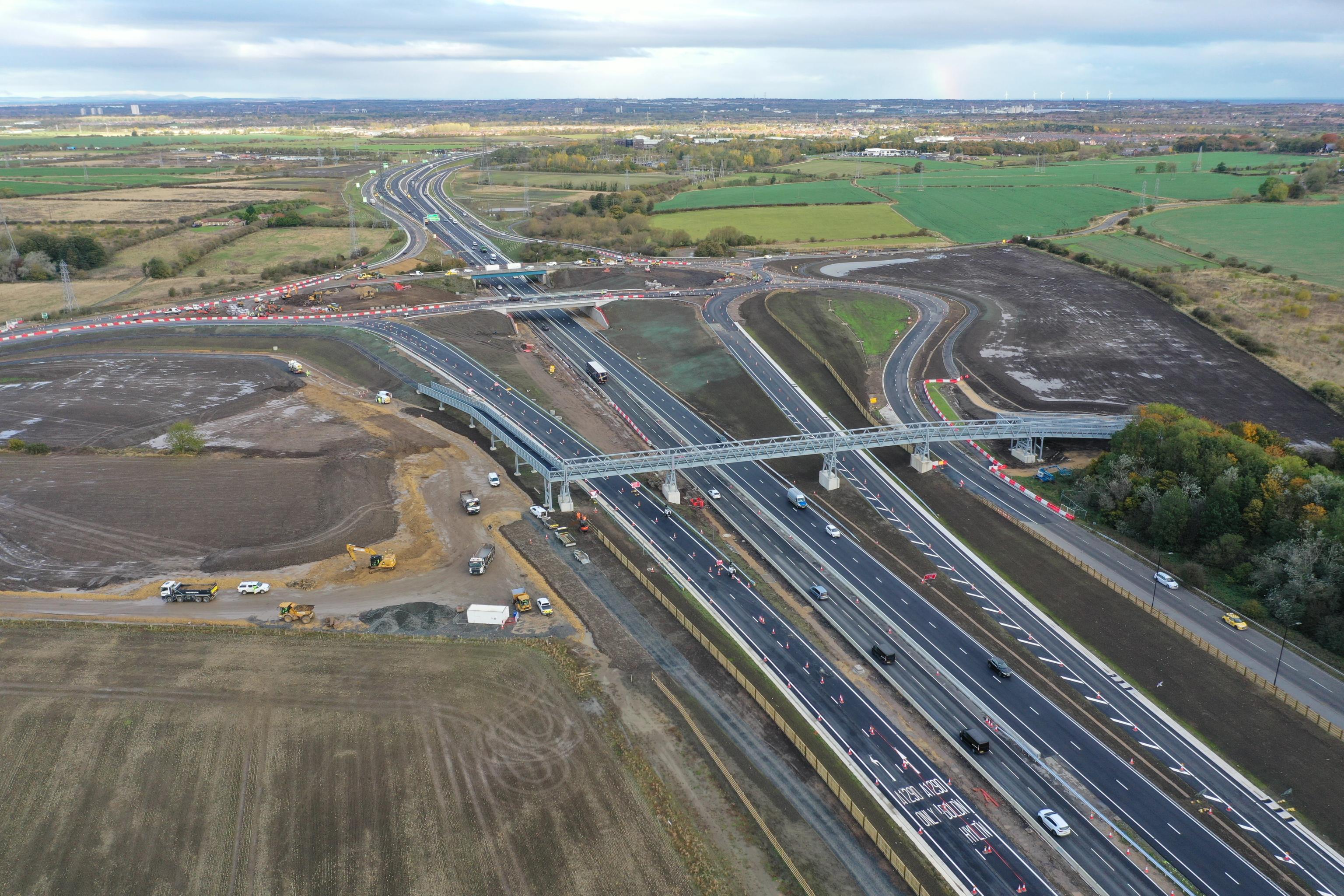 an aerial view of a highway with a bridge over it .