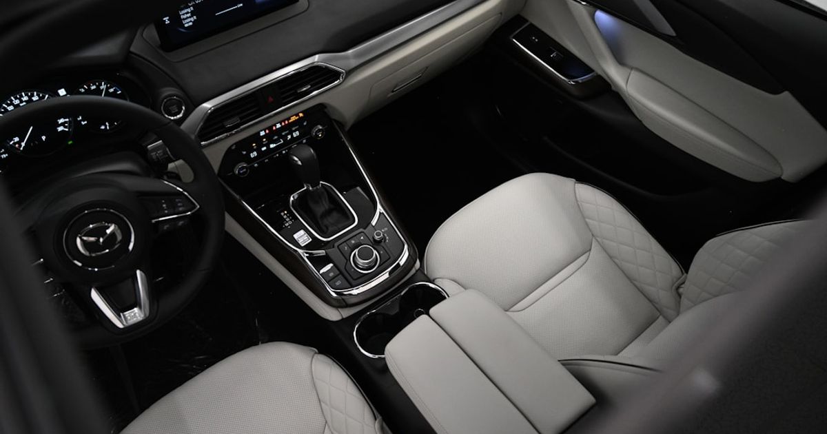 Mazda CarPlay Not Working — CX-5, Mazda 3, MX-5 Complete Fix Guide (2026) — the interior of a car with a steering wheel and dashboard