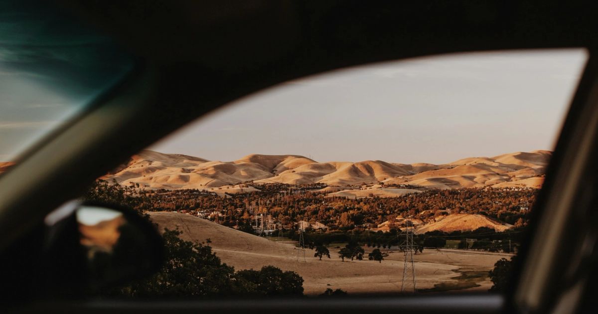 Desert mountains through a car window
