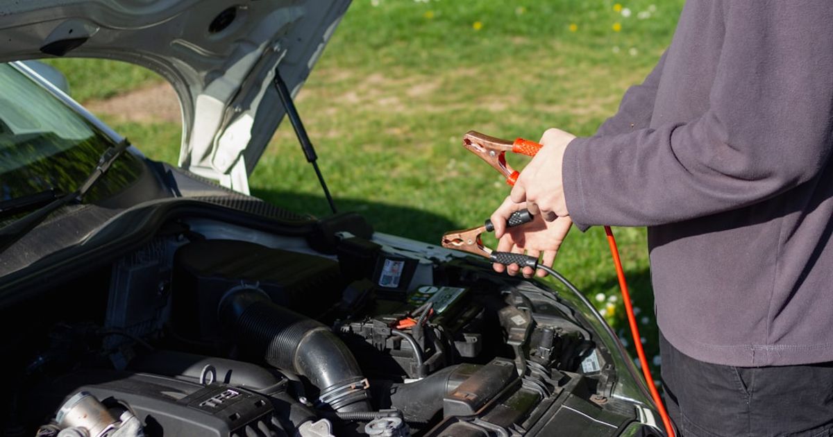 Toyota CarPlay Not Working — Camry, RAV4 & Entune Fix Guide (2026) — person in gray jacket standing beside black motorcycle