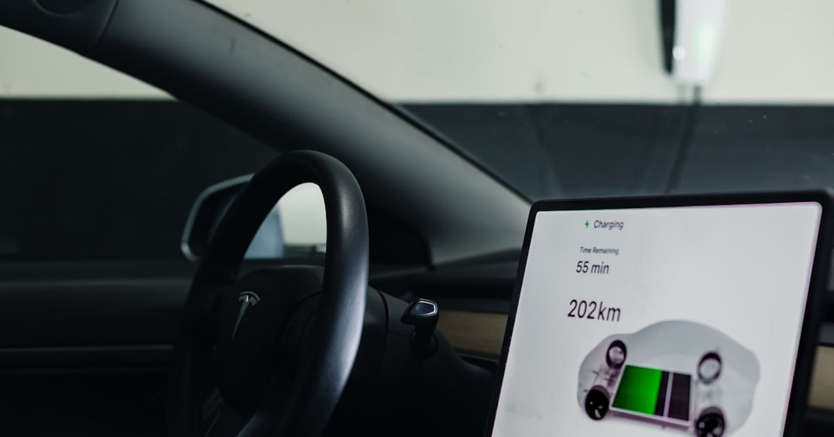 Tesla CarPlay Is Coming — But Not for Your Tesla Yet. Here's What Works Today — a picture of a car dashboard with a display on the dashboard