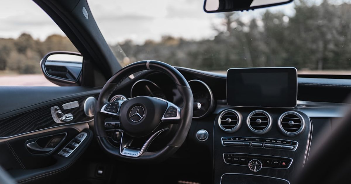 CarPlay Widgets in iOS 26: The 11 That Actually Help (And the 3 That Don't) — black mercedes benz car interior