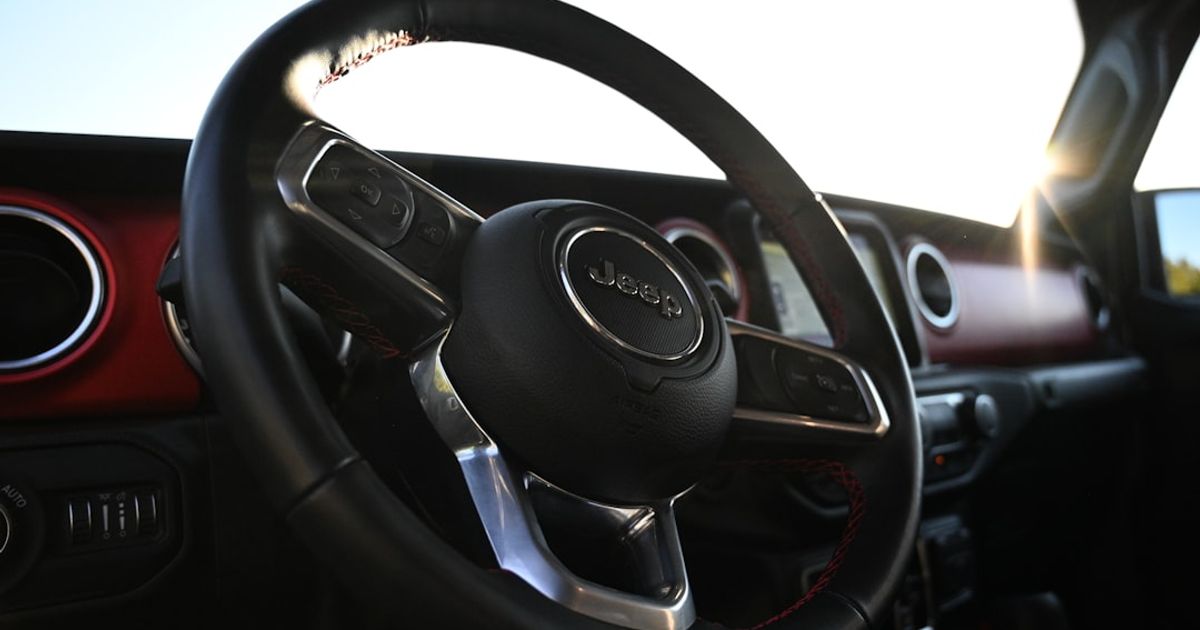 Jeep CarPlay Not Working — Wrangler, Grand Cherokee & Gladiator Fix Guide (2026) — the interior of a car with a steering wheel