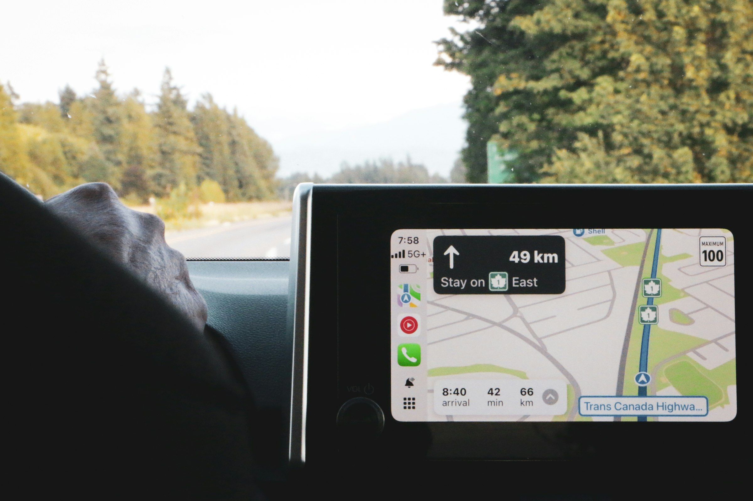 Apple CarPlay navigation on a car screen with the open road ahead