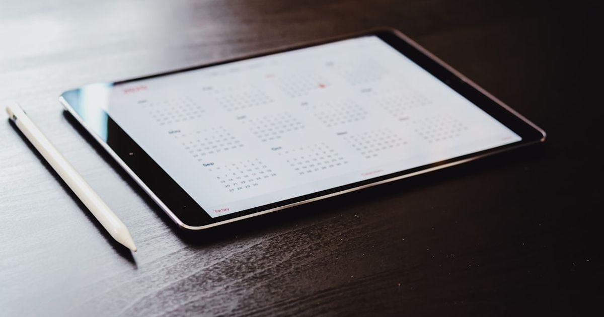 How to Add a Calendar Widget to CarPlay in iOS 26 — white ipad on brown wooden table