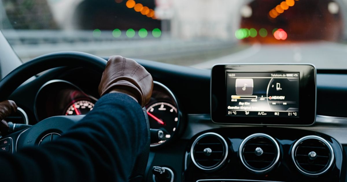 CarPlay Video Streaming Restrictions: What's Blocked, and the Legal Ways Around It — person inside vehicle holding steering wheel