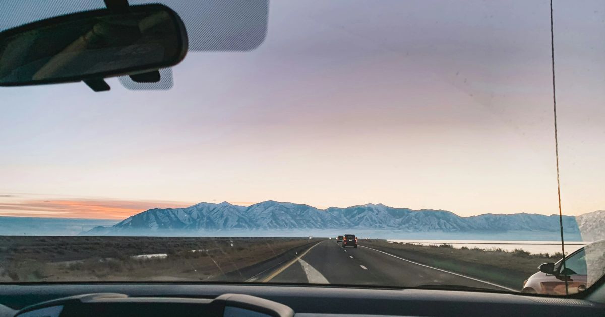 Driving on an open road at sunset