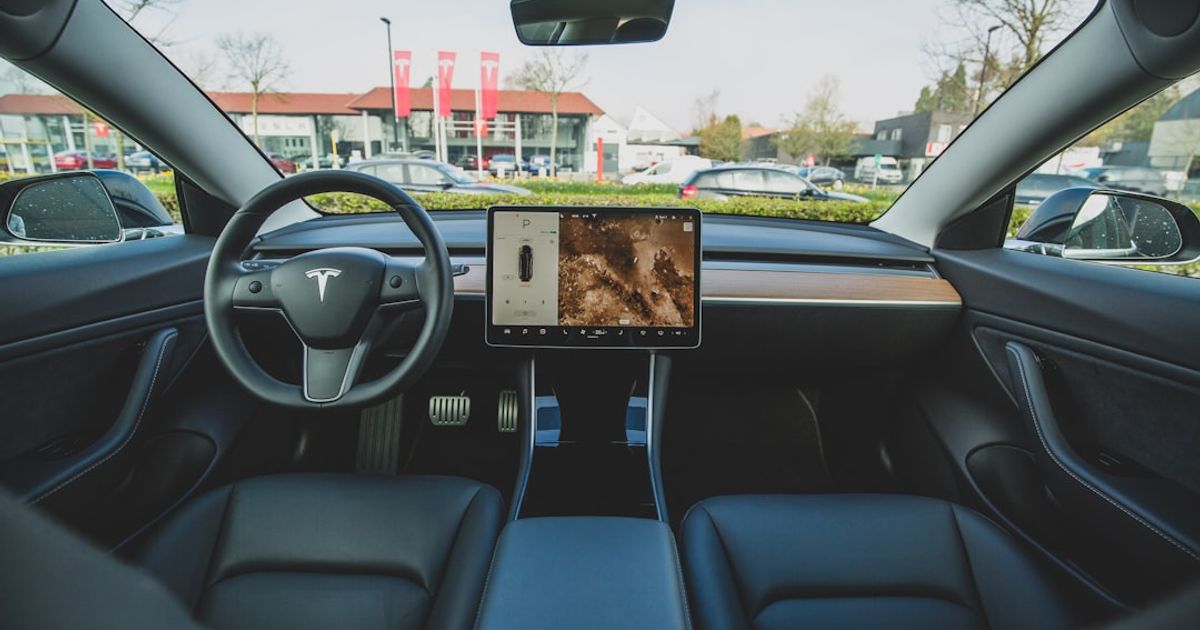 Does Tesla Have Apple CarPlay? June 2026 Update — What Was Promised, What Shipped — black car interior \