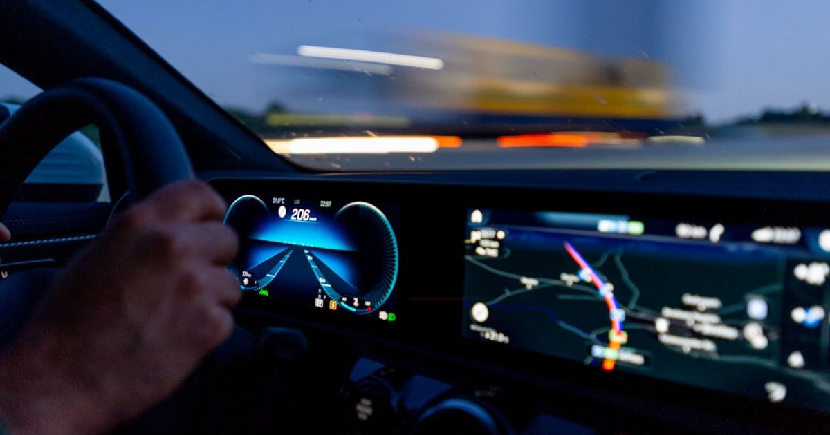 What Is Apple CarPlay? A Plain-English Guide for 2026 — person's hand on steering wheel