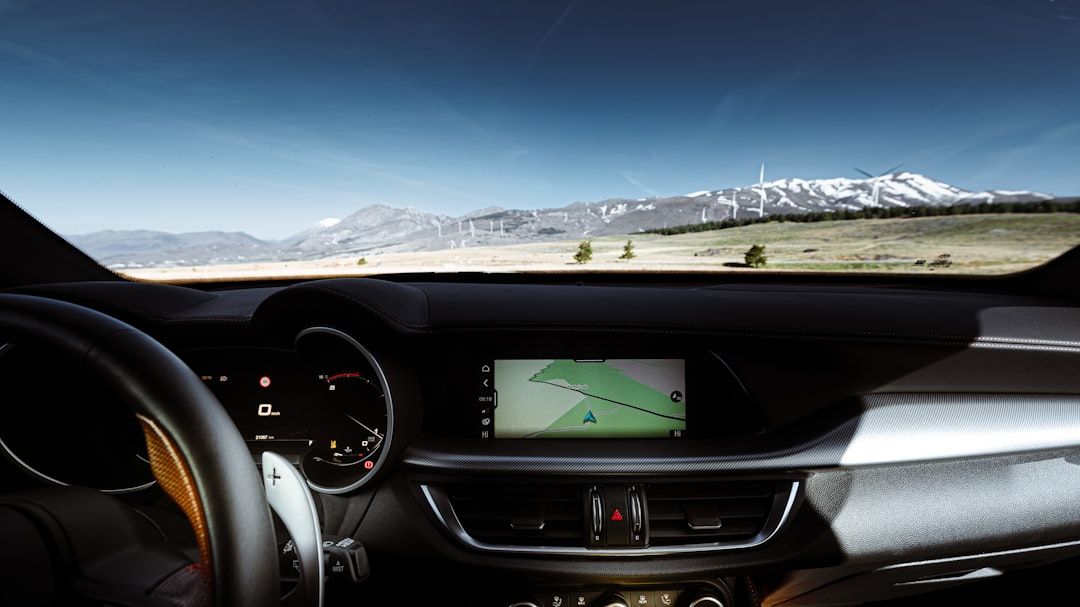 How to Add a Music Widget to CarPlay in iOS 26 — Driving through a scenic mountain landscape