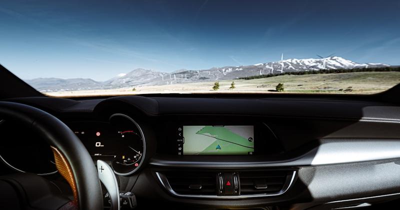How to Add a Music Widget to CarPlay in iOS 26 — Driving through a scenic mountain landscape