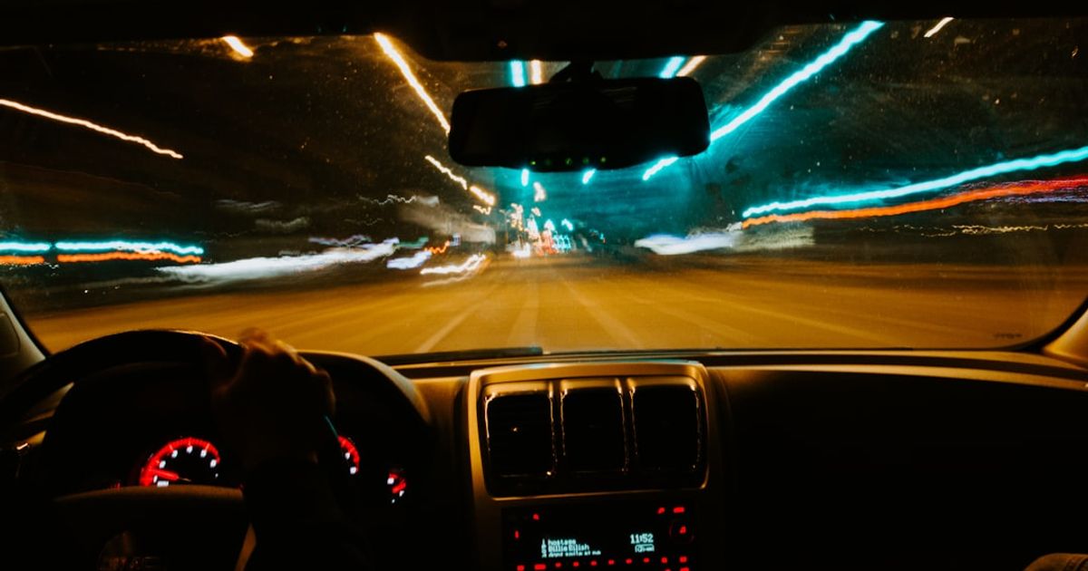 CarPlay Black Screen? How to Fix a Blank Display (iOS 26) — person driving car during night time