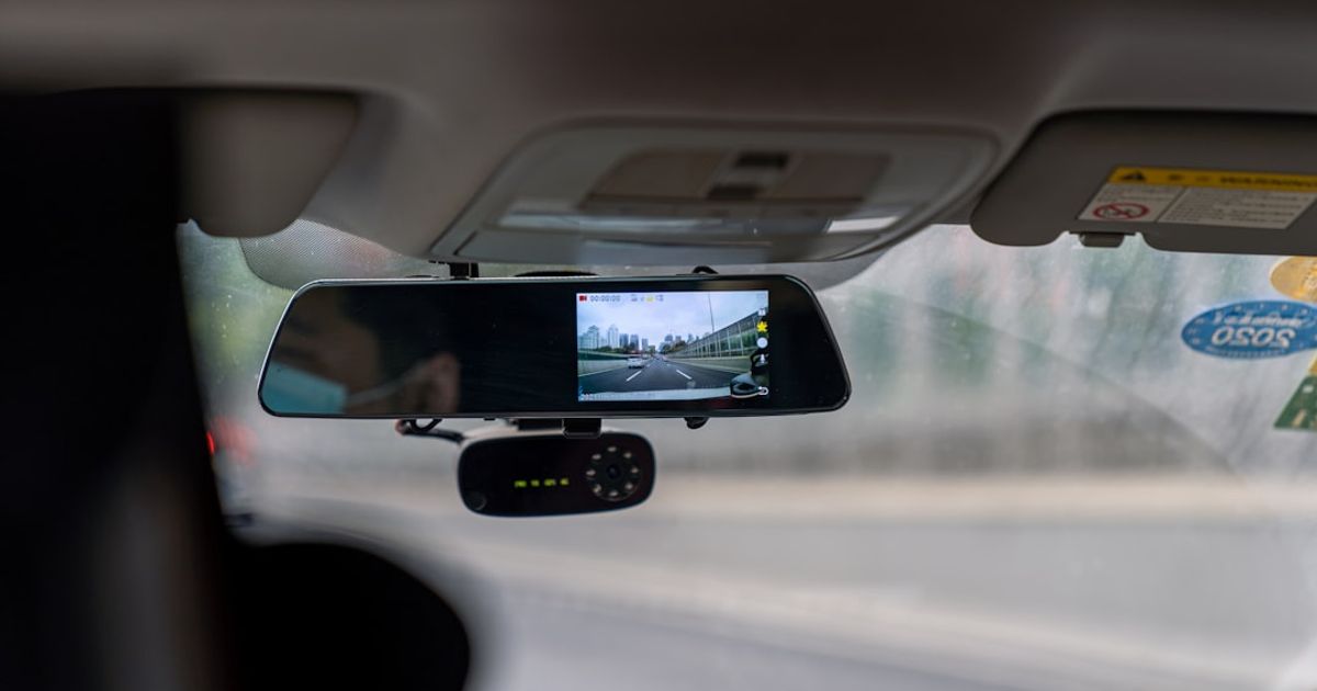 Can You Watch Video on CarPlay? iOS 27 Makes It Official — car side mirror with water droplets