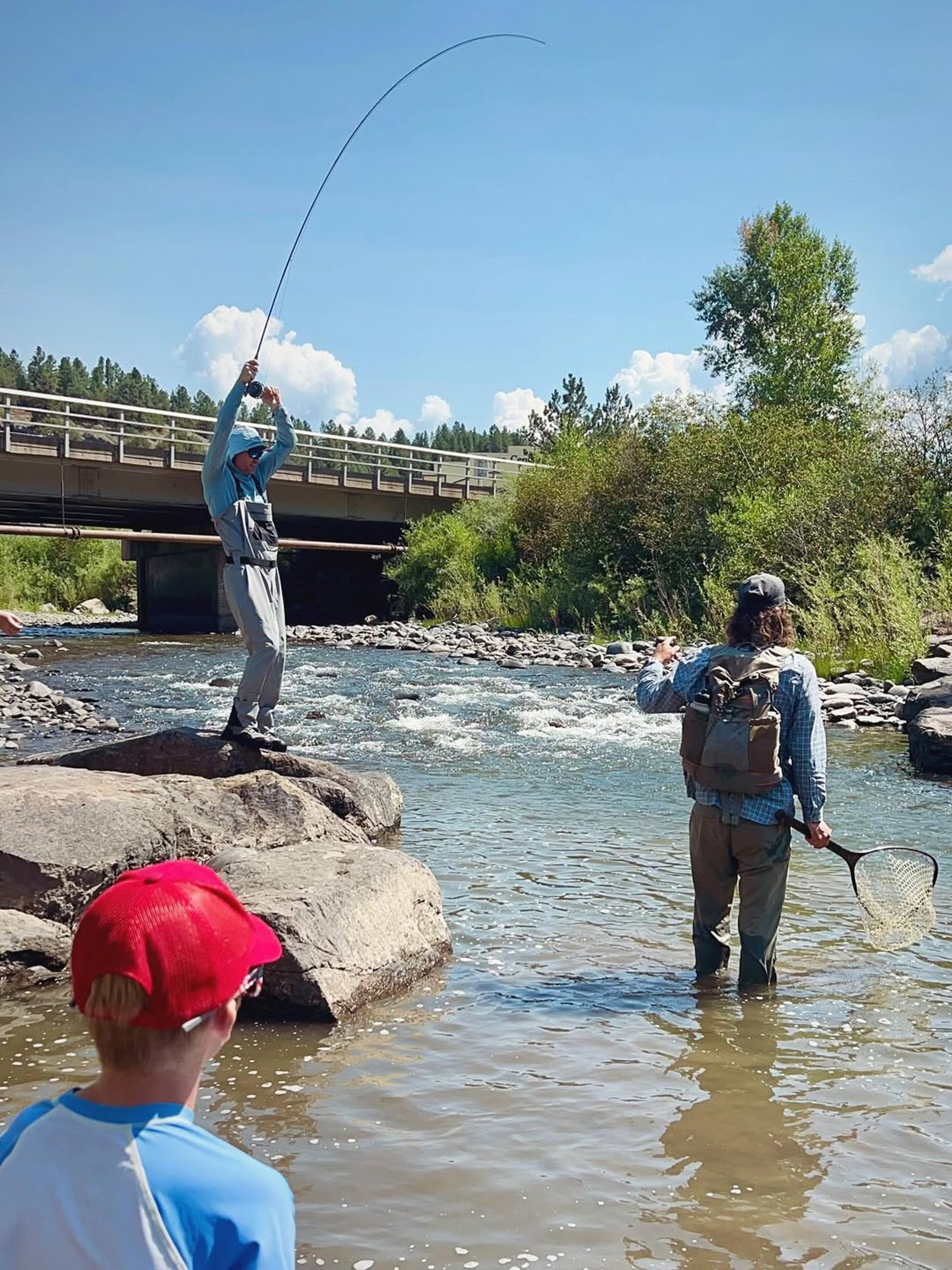 man reeling in fish